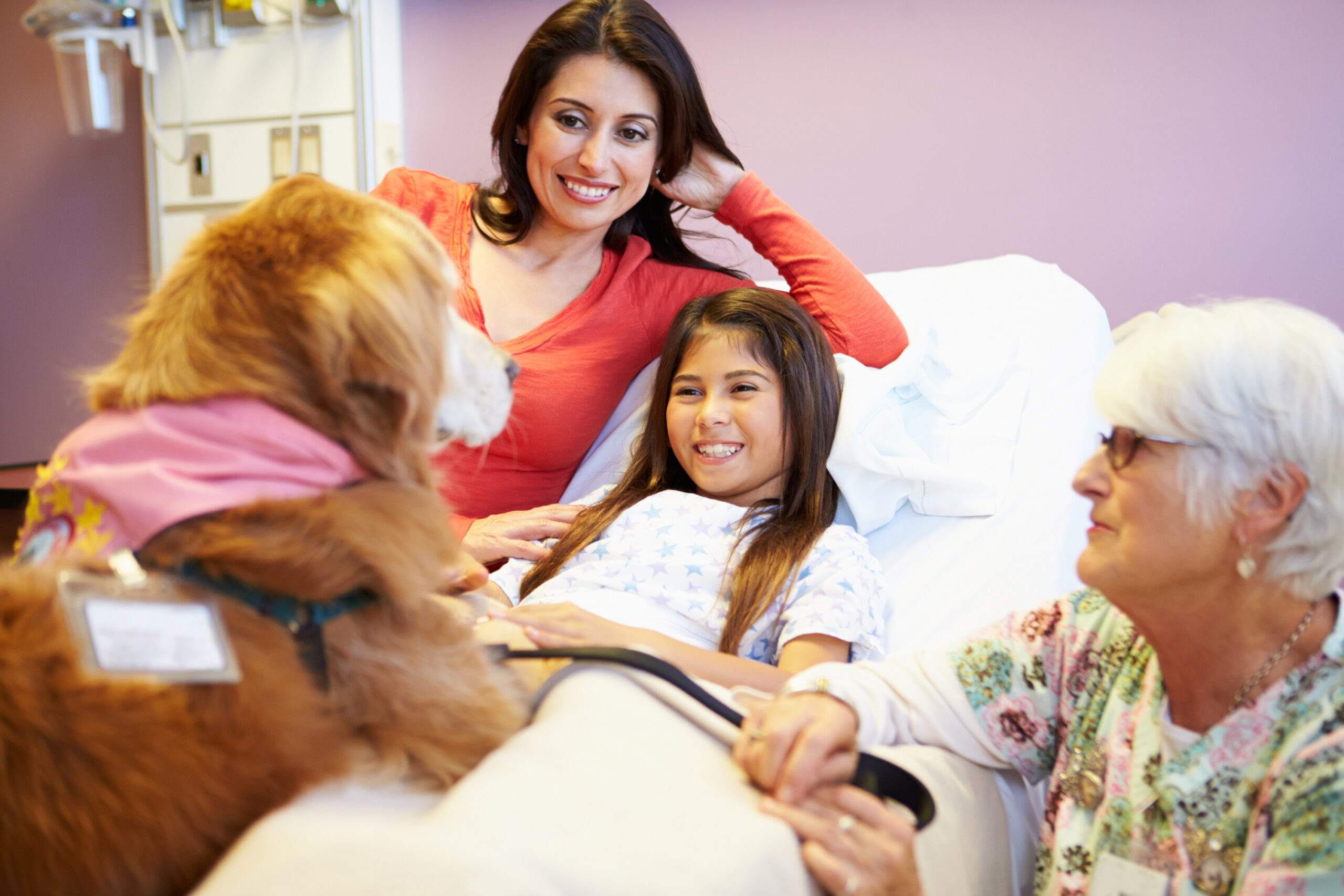 young-girl-being-visited-in-hospital-by-therapy-dog